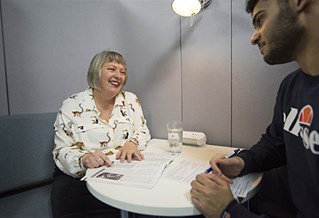 Careers adviser with a student at a desk