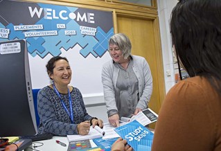 Advisers speaking with a student at the careers desk