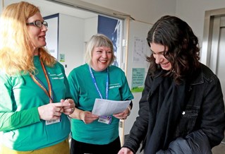 Advisers speaking with a student at a careers fair
