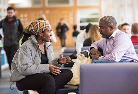 Two people chatting in a communal area