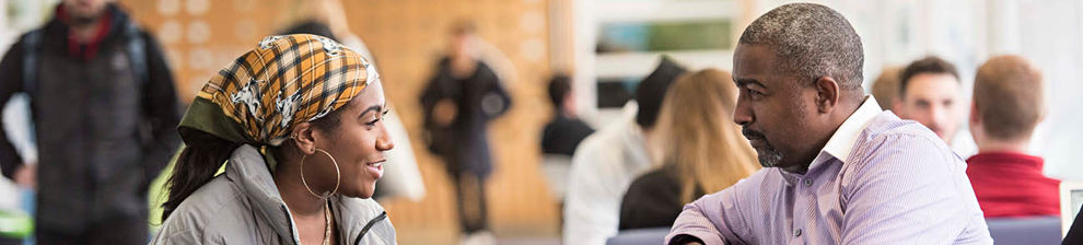 Student and mentor chatting on campus