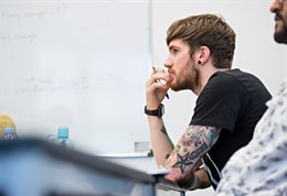 Male student with arm tattoos