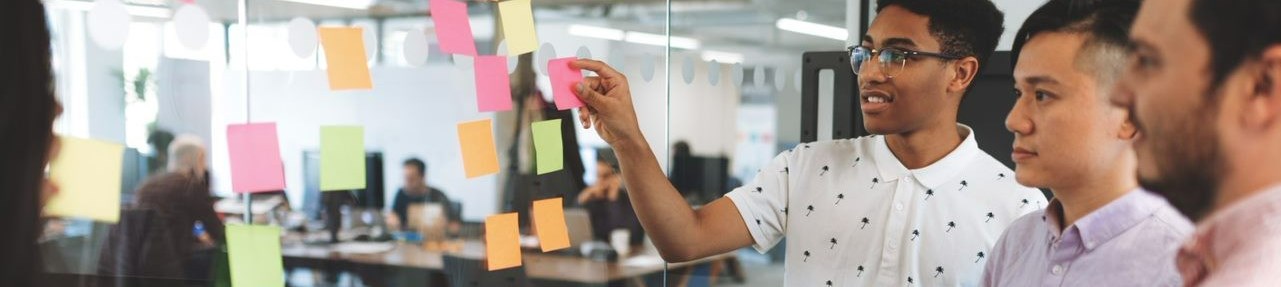 International students making decisions using Post-it notes on a mirror screen