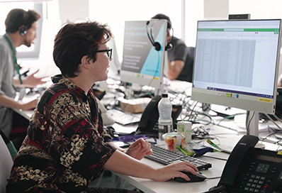 student using a computer to make a call in an office environment