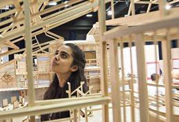 Student surrounded by architectural models