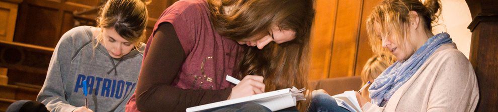 Three students writing