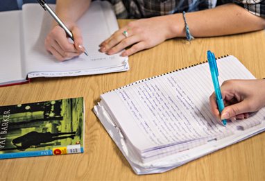 Students writing in notebooks
