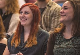 Two students smiling in a seminar