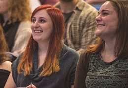 Two students smiling in a seminar