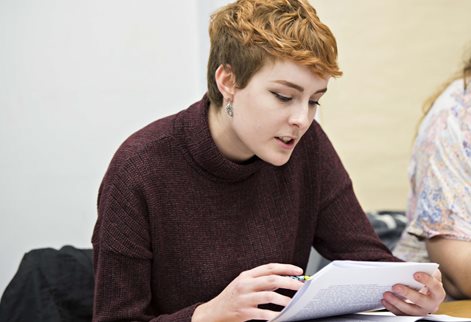 Student reading documents intently