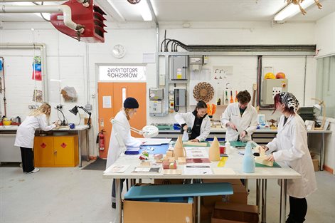 Group of students around a table making models