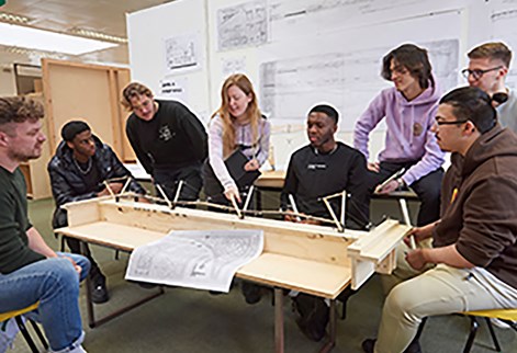 Students presenting architecture project to lecturer
