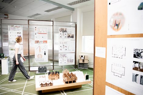 Student walking across studio at art show