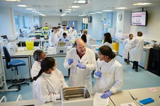 Lecturer with students in specialist lab