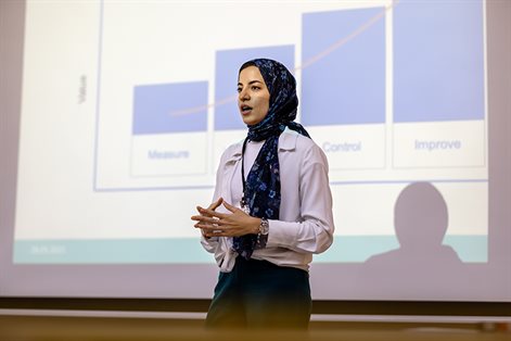 Woman wearing headscarf presenting at seminar