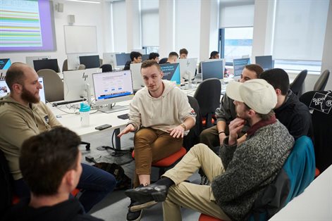 Group of students  discussing work in a computer room