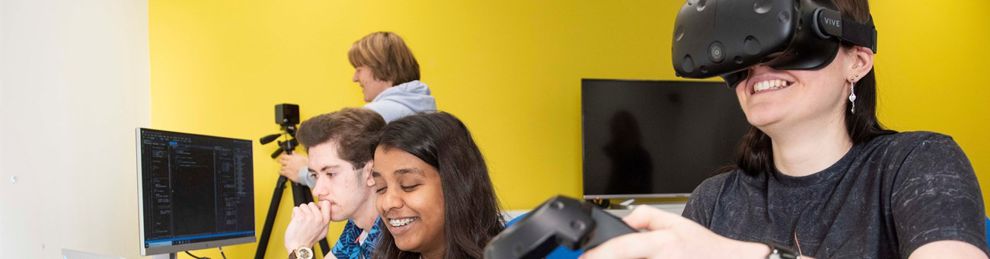 Students using VR equipment and computers