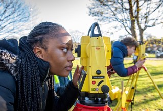 Female civil engineering student using total station Dec 2021