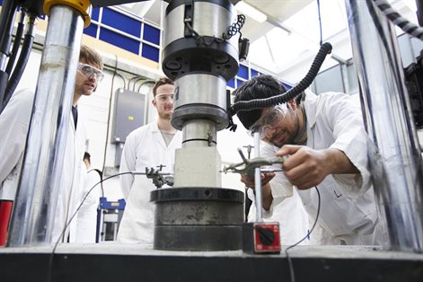 Student working with civil engineering facility for testing concrete