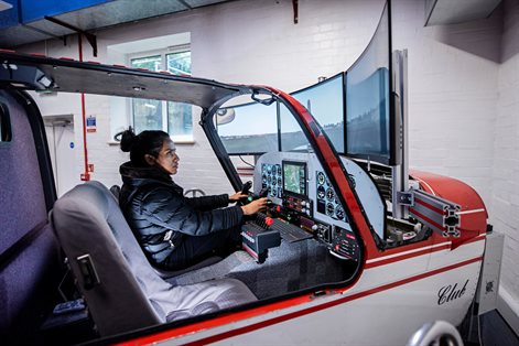 Female student in aircraft simulator
