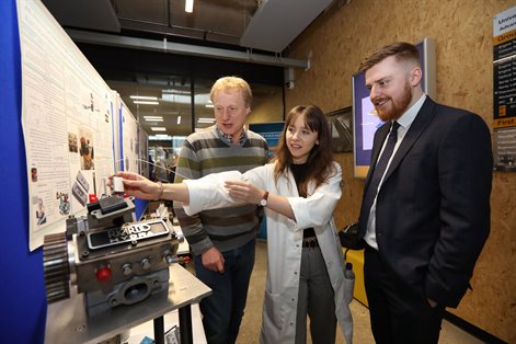 Female student presenting project to professional