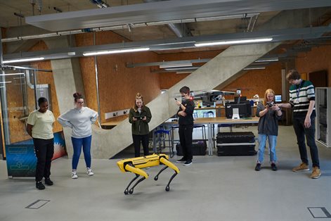 Group of students working with the robotic dog