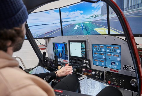 Looking over a students shoulder working in the engineering flight simulator