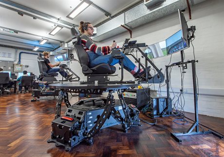 Student with long hair in a ponytail on flight simulator