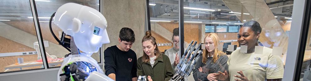 Students with humanoid in robotics lab