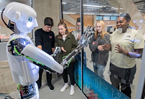 Students with humanoid in robotics lab