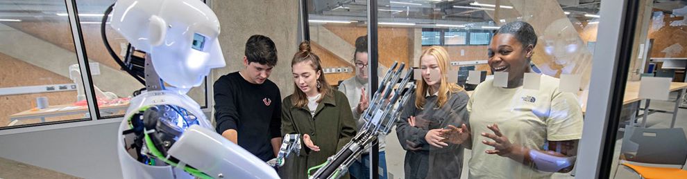 Students with humanoid in robotics lab