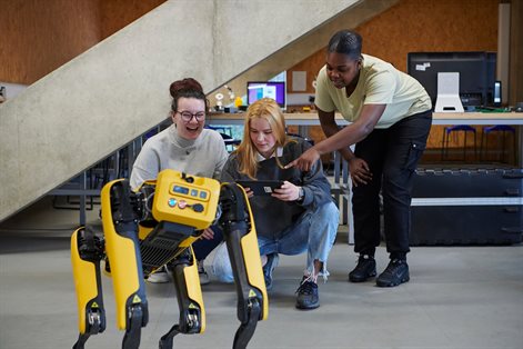 Three female students and robot dog