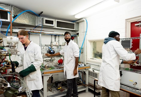 Three students working in the engineering STEP lab