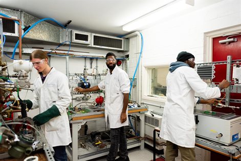 Three students working in the engineering STEP lab