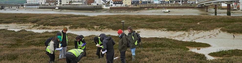 Group of environment students working in Shoreham mudflats