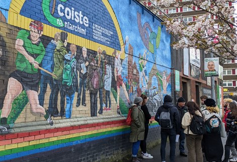Student group infront of a political mural on a field trip to NI