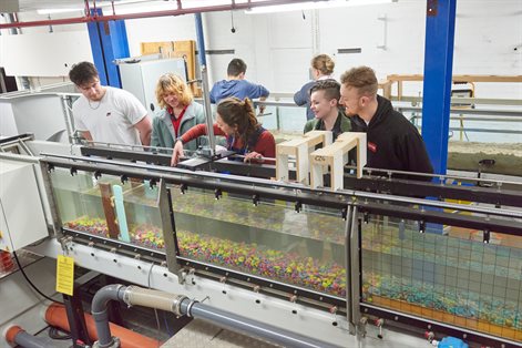 Students and lecturer working with the flume
