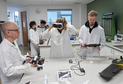 Students and technician using drone equipment in the lab