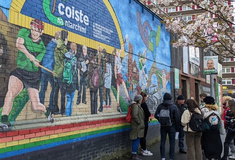 Students infront of a political mural on a field trip to NI