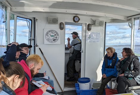 Students working on a boat during a field trip to NI