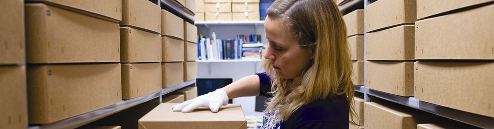 woman in archives with boxes