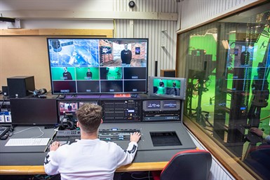 male student using journalism equipment