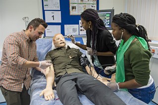 Pharmacy students working with patient simulator