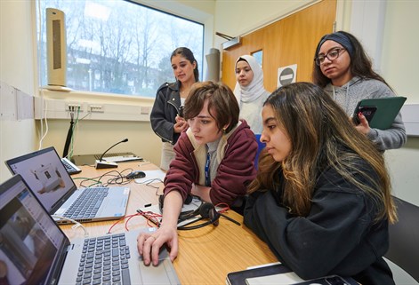 Students working on laptop in clinical simulation suite
