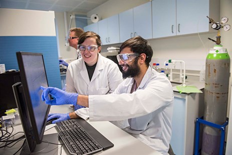 Two students in a lab using a computer