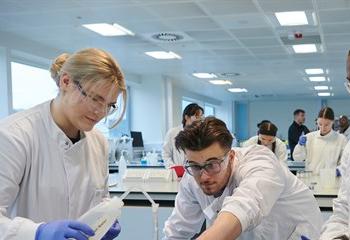 Three pharmacy students in a laboratory
