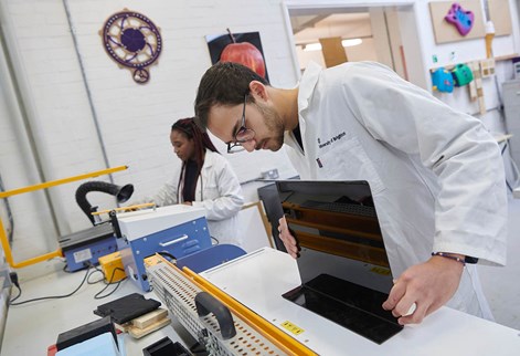 Two students working in the product design workshop