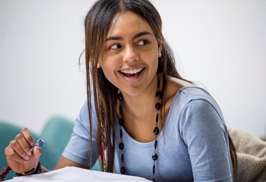 Student laughing at a joke in a seminar