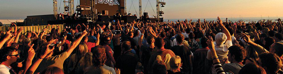 Crowds of people on Brighton beach at a Fatboy Slim concert