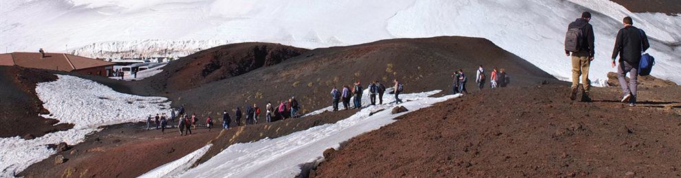 Students walking over snowy hills on field trip abroad.
